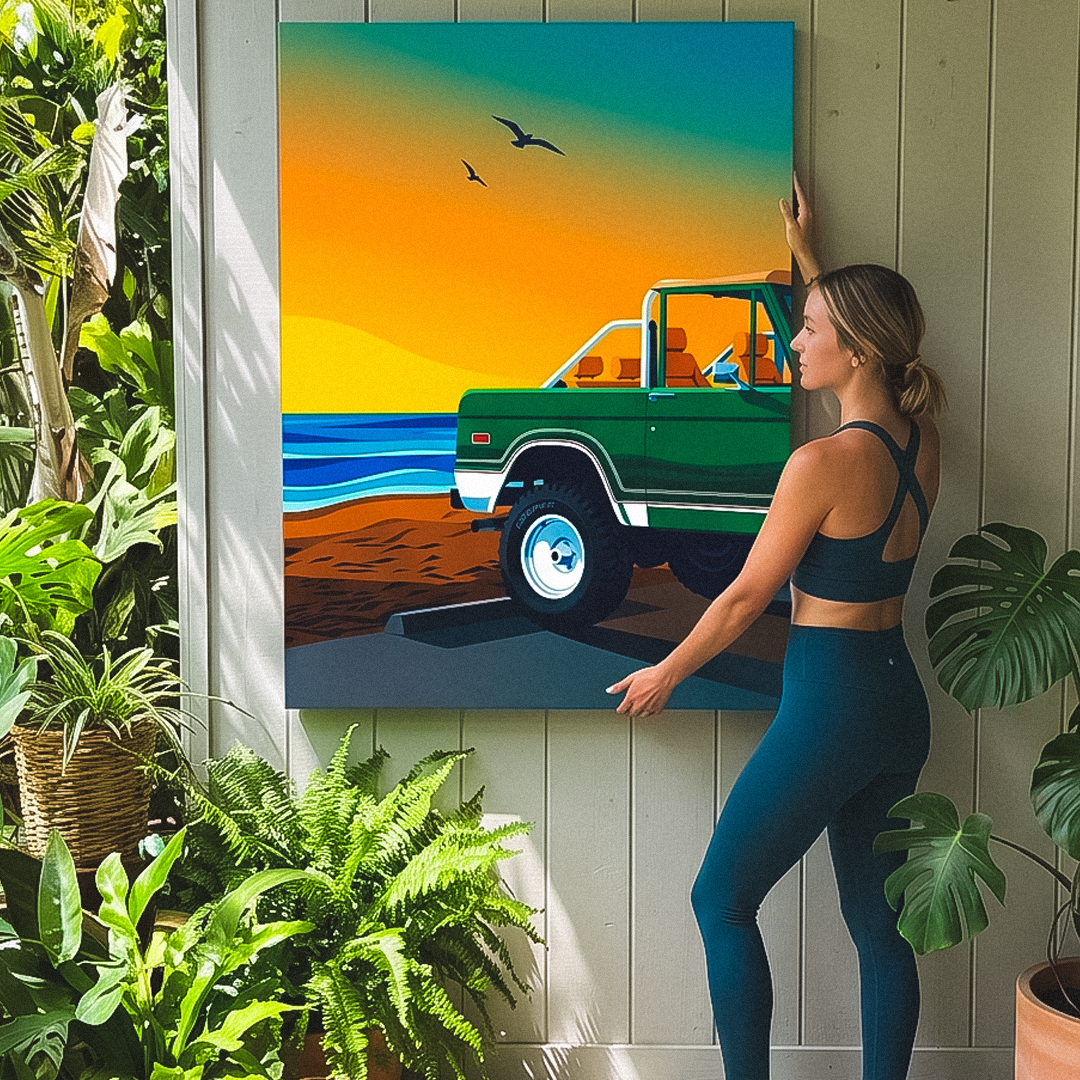 Woman standing next to a painting of a green truck on a beach
