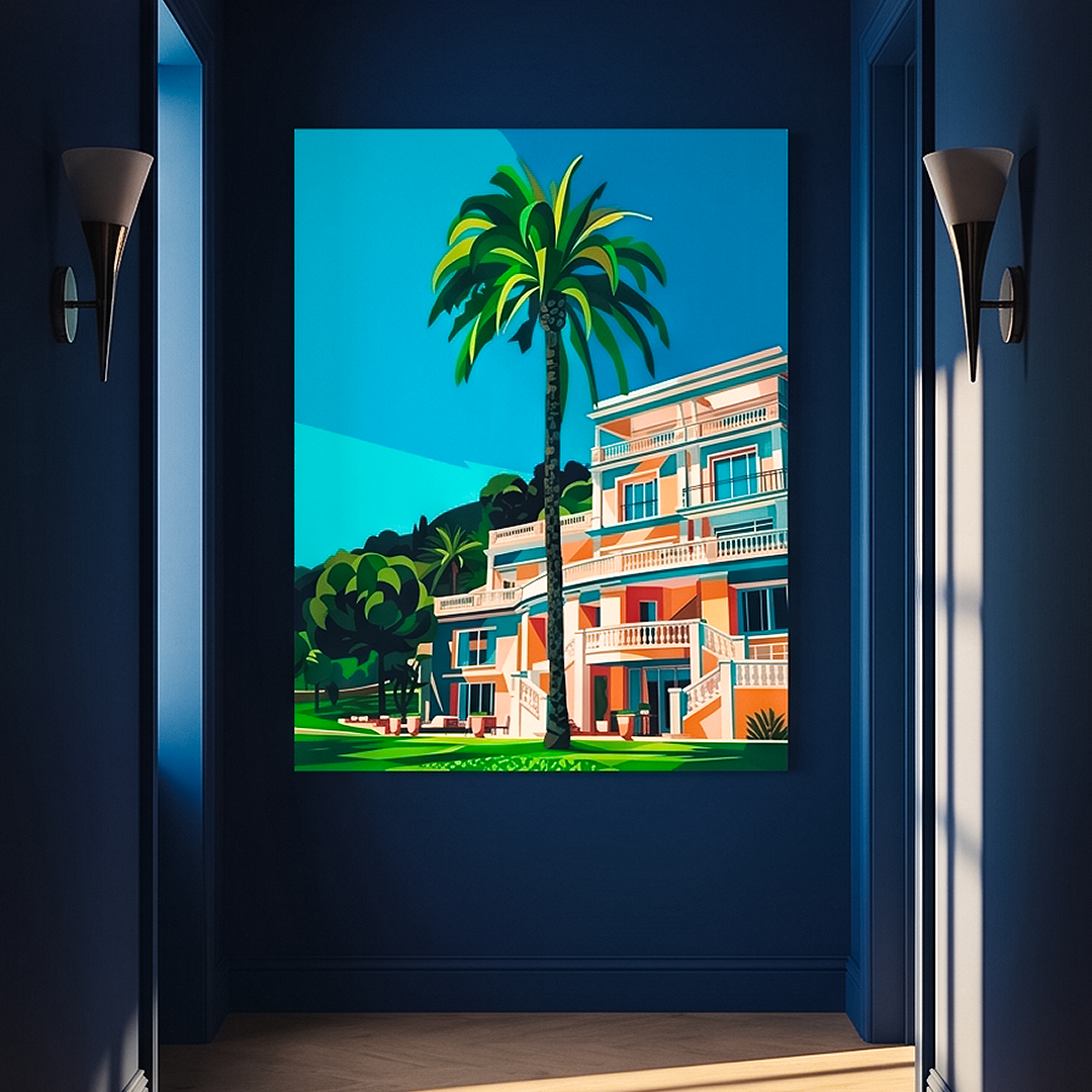 A vertical framed art print depicting a vibrant tropical resort scene with a palm tree and a modern building, displayed on a dark blue wall in a hallway with wall sconces.