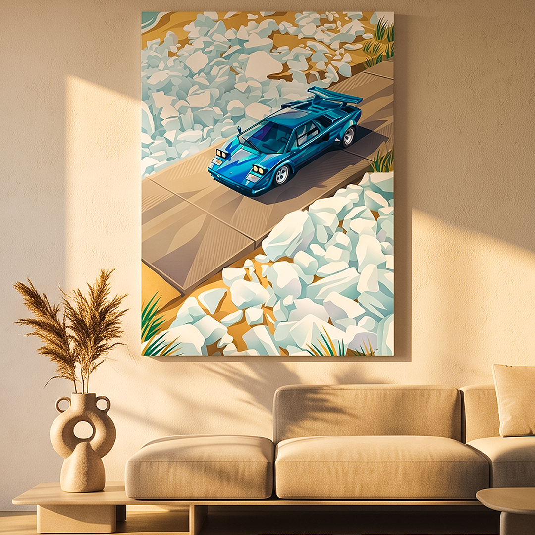 A framed wall art print showing a blue sports car on a wooden path surrounded by white rocks, displayed above a beige sofa in a modern living room setting.
