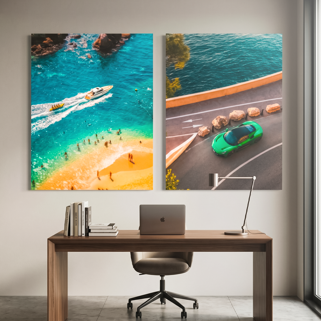 Two large wall art pieces above a desk with a laptop and chair.